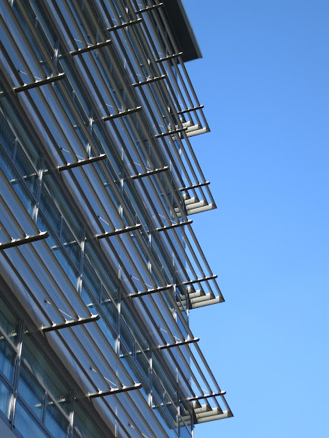 Tall building against blue sky with silver balconies - at least, I think they must be balconies!