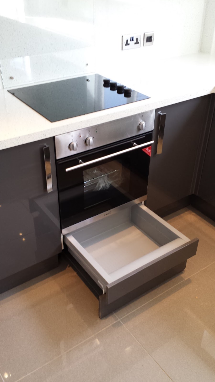 Elm Kitchens and Joinery Howdens Kitchen in dark grey gloss with a