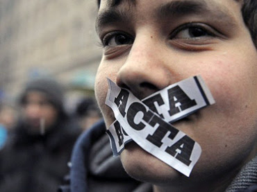 A demonstrator with ACTA stickers on his mouth takes part in a protest against Poland's government plans to sign international copyright agreement ACTA (Anti-Counterfeiting Trade Agreement), in front of the European Union office in Warsaw on January 24, 2012