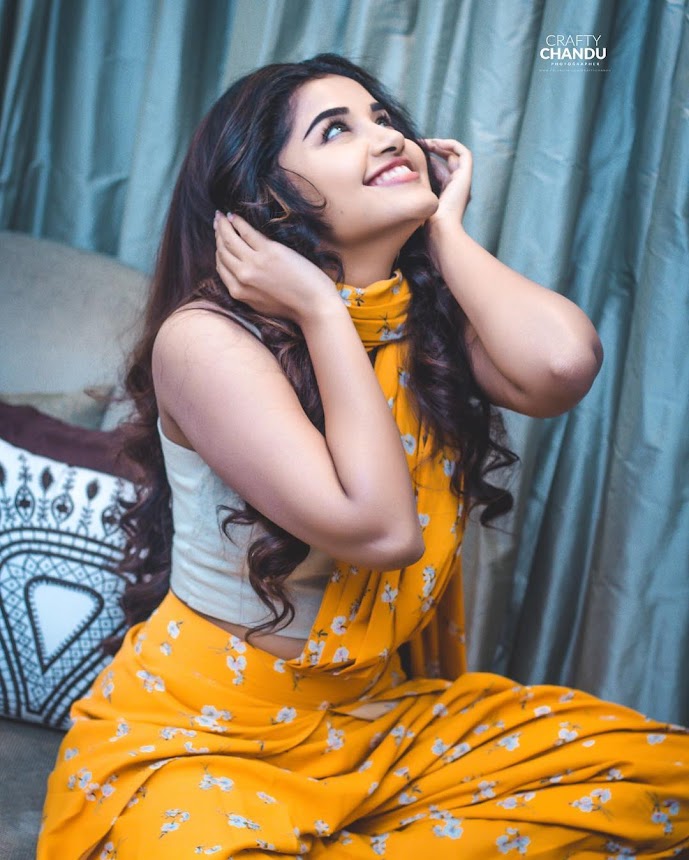 Anupama Parameswaran cute smile in sleevless choli top and saree