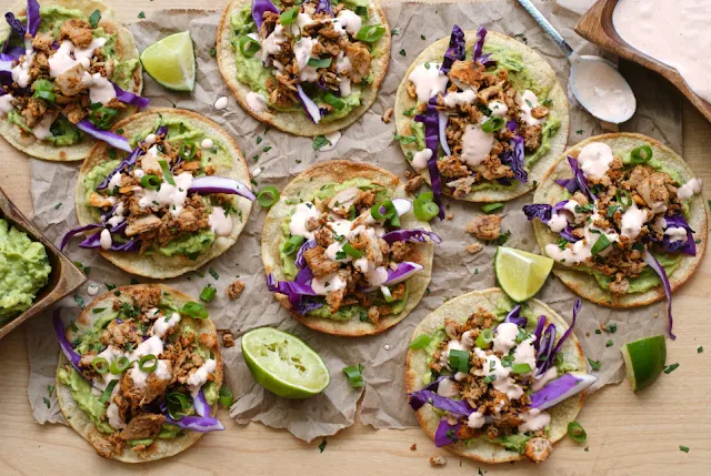 Tuna Tostadas with Chipotle Crema are full of bold flavor, made by topping crisp baked tortillas with seasoned tuna, creamy avocado, fresh red cabbage, and a spicy chipotle crema.
