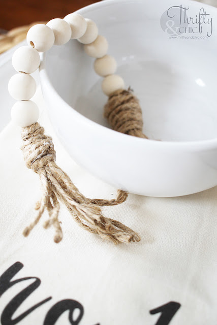 wood bead garland in white bowl