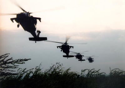 four Black Hawk helicopters in flight