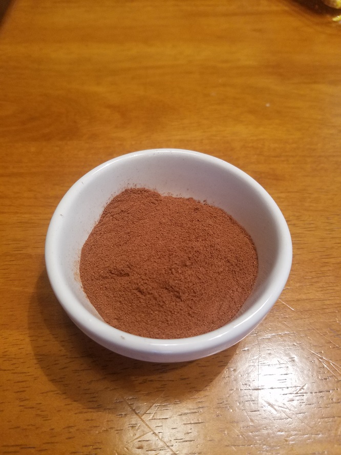 This is a recipe for homemade pumpkin pie spice. All the spices in one white bowl mixed together then put into a glass jar for using in pumpkin recipes.