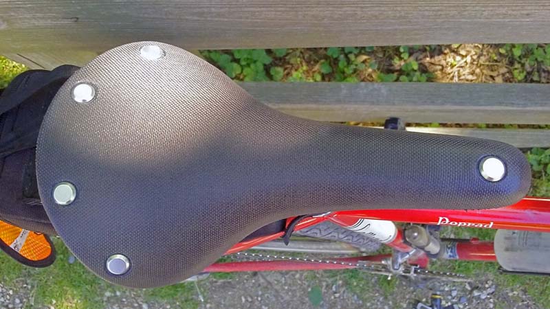 Brooks Cambium Saddle view from Top leaning against fence.