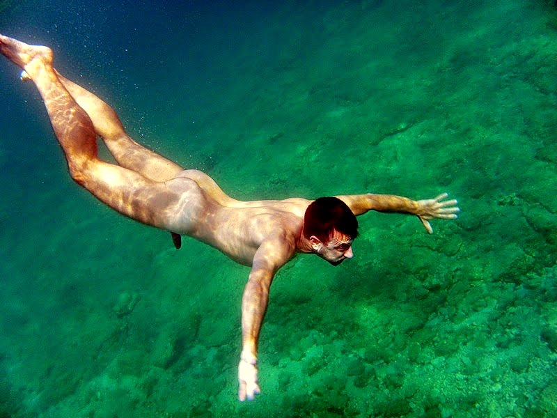 Naked men diving.