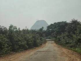The biker stopping to drink coconut water at the base of Kabbaldurga