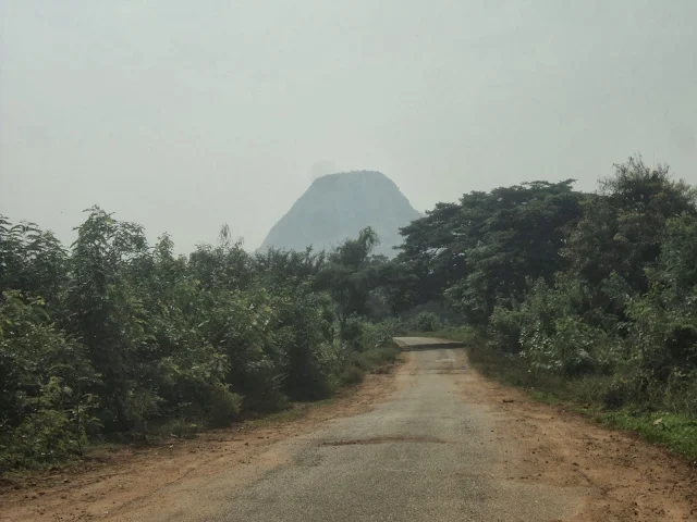 The biker stopping to drink coconut water at the base of Kabbaldurga