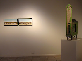 Two wall pieces and a building on display at the Alex Asch exhibition at Beaver Galleries.