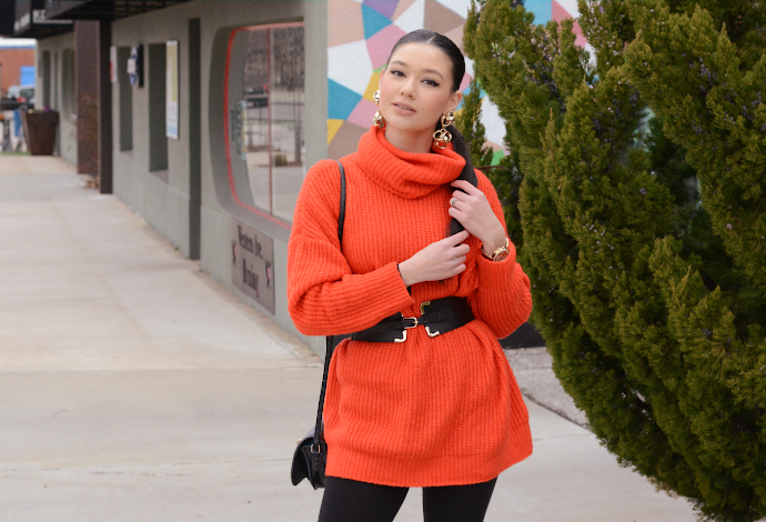 orange turtle neck knit sweater, over the knee lace up boots, waist belt