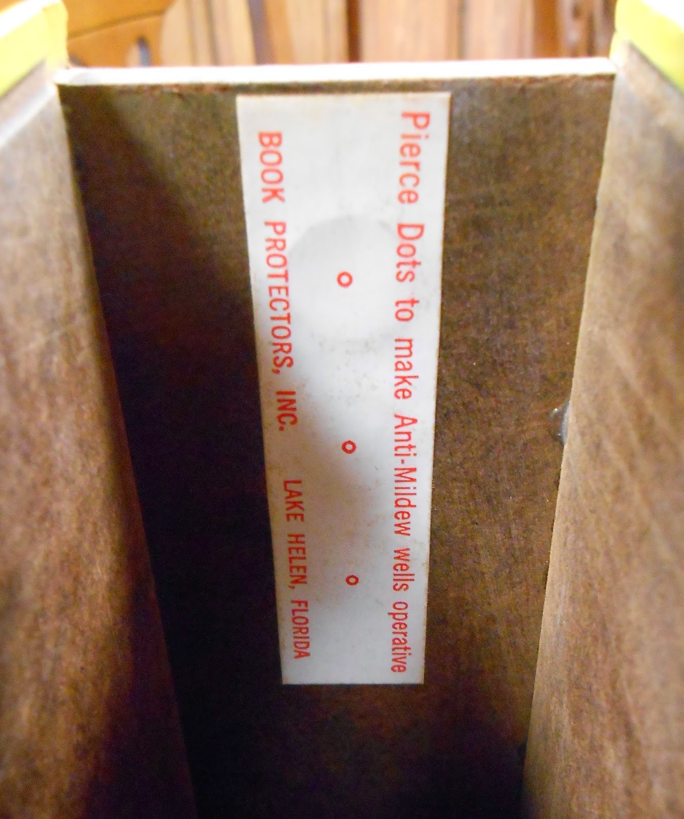 A tag inside the box, reading "Pierce dots to make anti-mildew wells operative."