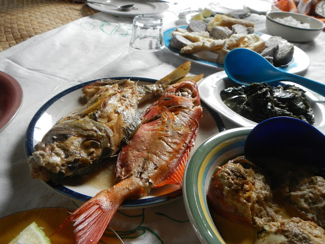 Top: Dalo and Taro. Left center: Fried reef fish. Right center: Pulasami. Lower right: Shelled Land Crab meat severed in back shell or carapace of the same.