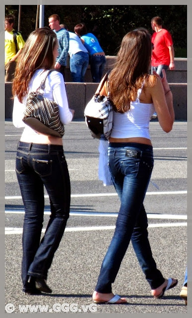 The girls in blue jeans in the street