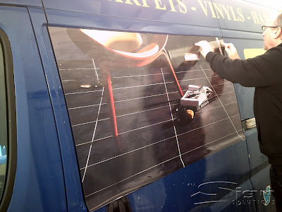 All Sign Solutions fitting the new flooring graphics full colour printed vinyl to the panel of Farleys van.
