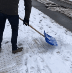 This man shovels snow at a bus stop for blind people This man shovels snow at a bus stop for blind people