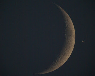 The moon and Venus. Venus looks brighter than the moon although the moon's brightness is higher