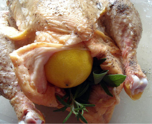 Put the lemon inside the chicken's cavity, with the bunch of herbs.