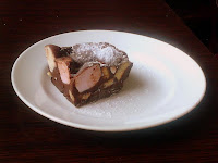 photo - rocky road on white china plate, big lumps of marshmallow, dusted with icing sugar