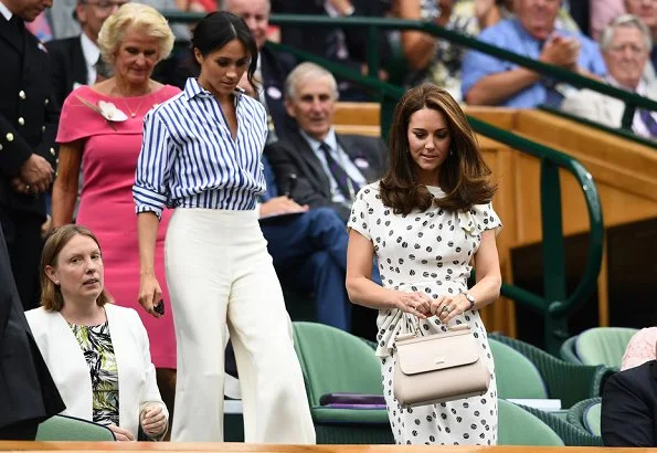 Kate Middleton wore a bespoke Jenny Packham dress. Meghan Markle wore Ralph Lauren Striped Cotton Shirt and Charmain Silk Wide leg Pant