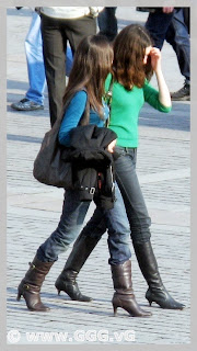 Two slim girls in high heels on the street 