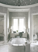 I love the light shades of grey wallpaper and how it picks up the viening of . (marble bath)