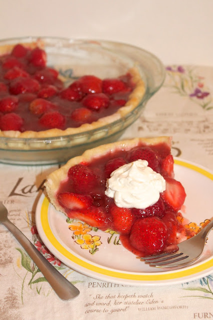 Strawberry season is the perfect time to make this fresh strawberry pie! Slice of fresh strawberry pie topped with whipped cream.
