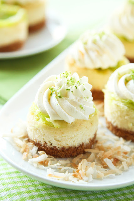 A plate of mini coconut lime cheesecakes on a bed of toasted coconut