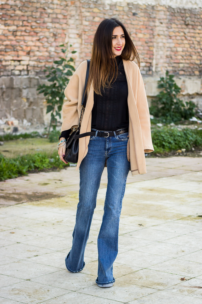 camel coat and flared jeans