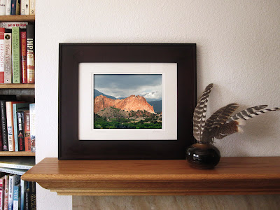 An iconic red stone mountain rises up against a stormy sky in Colorado's Garden of the Gods.