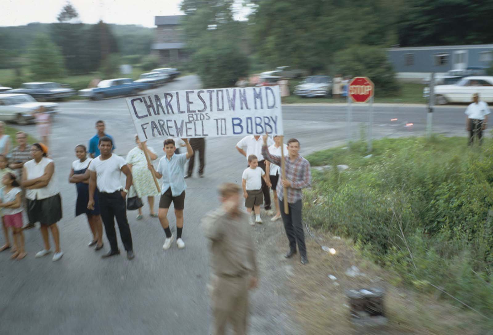 A sign is held up as the funeral train passes through Charlestown, Maryland, on June 8, 1968.