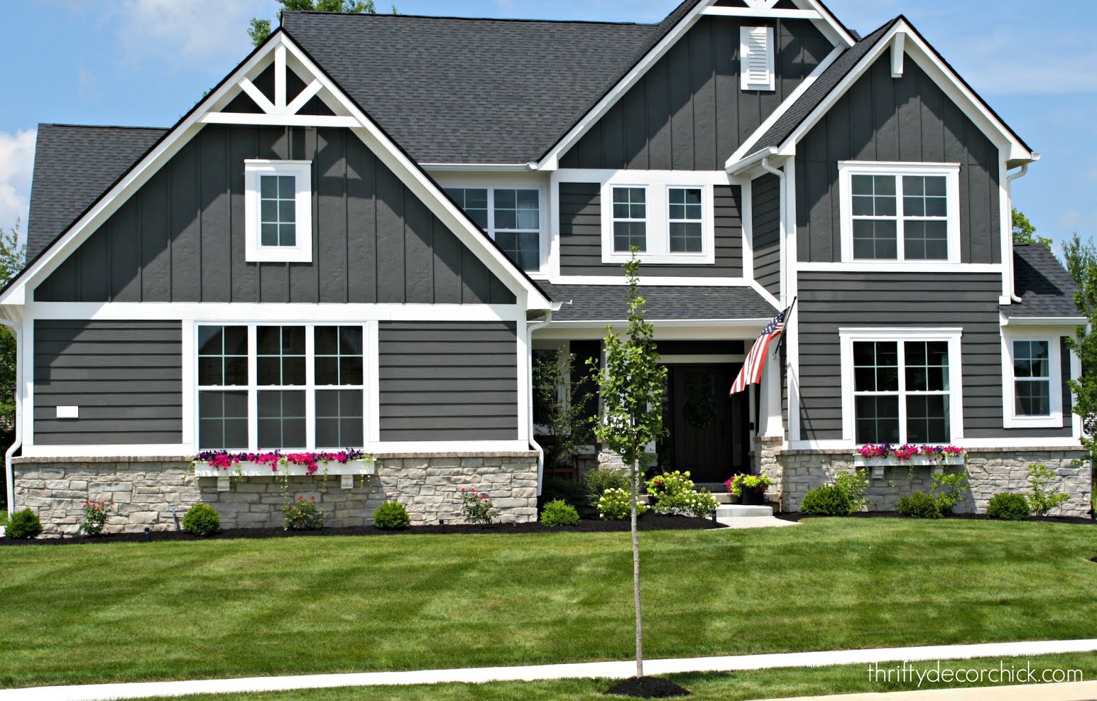 Dark gray Craftsman style home with gray paint white trim