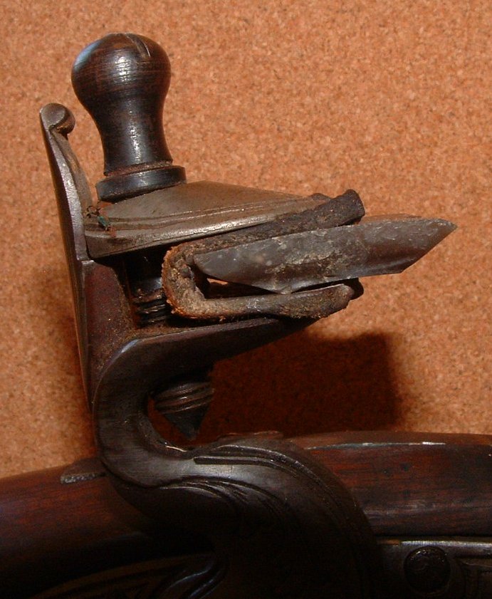 A Woodsrunner's Diary Fitting A Gun Flint In The Lock.