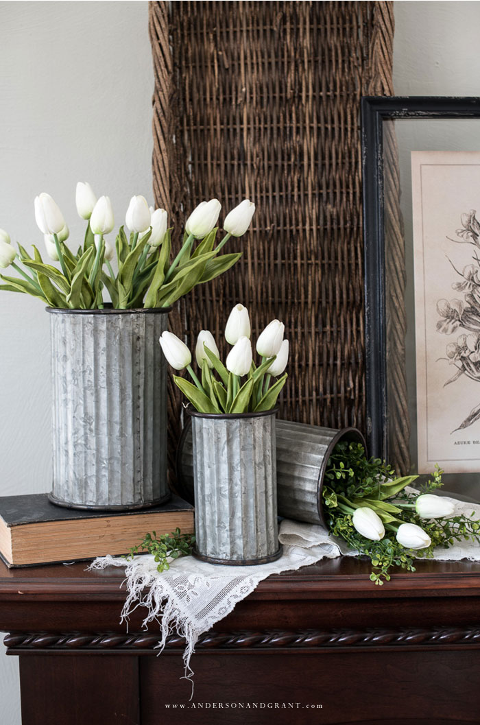 Three tin vases with tulips