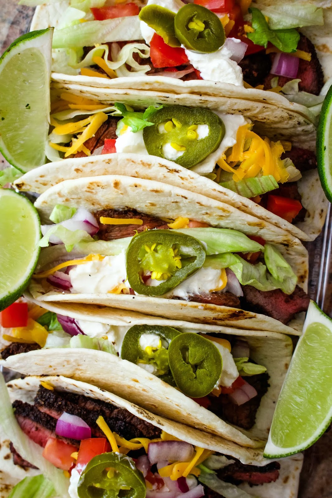 Grilled Sirloin Steak Tacos feature dry-rubbed grilled sirloin steak topped with all of your favorite taco toppings. You will want to make them all summer long! #tacos #steaktacos #grillingrecipe
