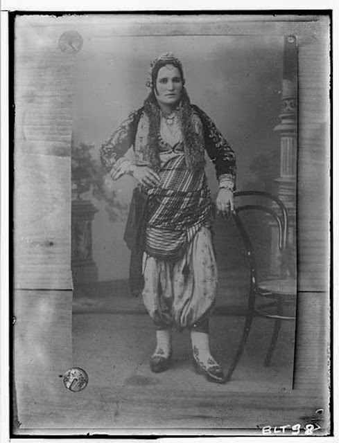 Reproduction of a photographic print of a Macedonian woman in pants, village Negochani (Niki)