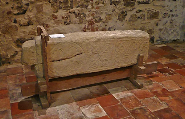The lower part of St Botolphs carved cross decorated with the heads of dogs or wolves that was found during excavations in 1977