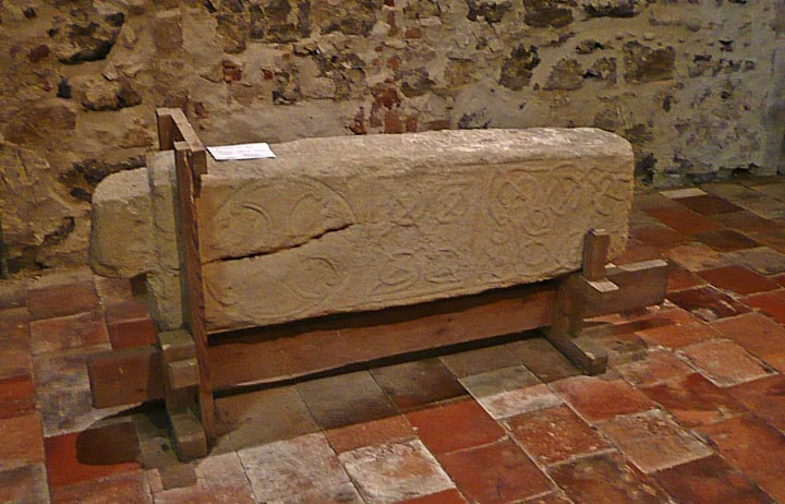The lower part of St Botolphs carved cross decorated with the heads of dogs or wolves that was found during excavations in 1977