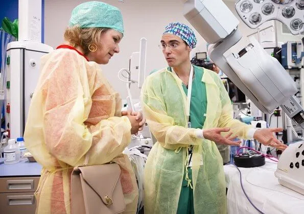 Queen Mathilde visited Queen Fabiola Children's University Hospital. The Queen wore a double breasted orange blazer by Ralph Lauren