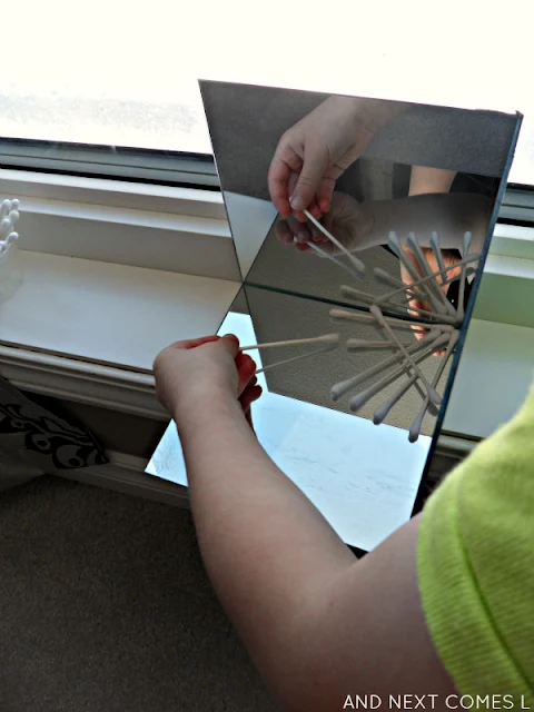 Creating cotton swab snowflakes and exploring symmetry in a DIY mirror box for kids