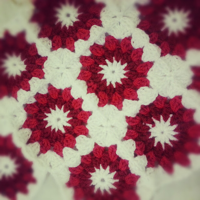 Crochet starburst cushion cover in red and white