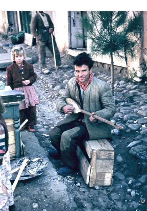Young Albanian playing traditional tool-like guitar by FIelder