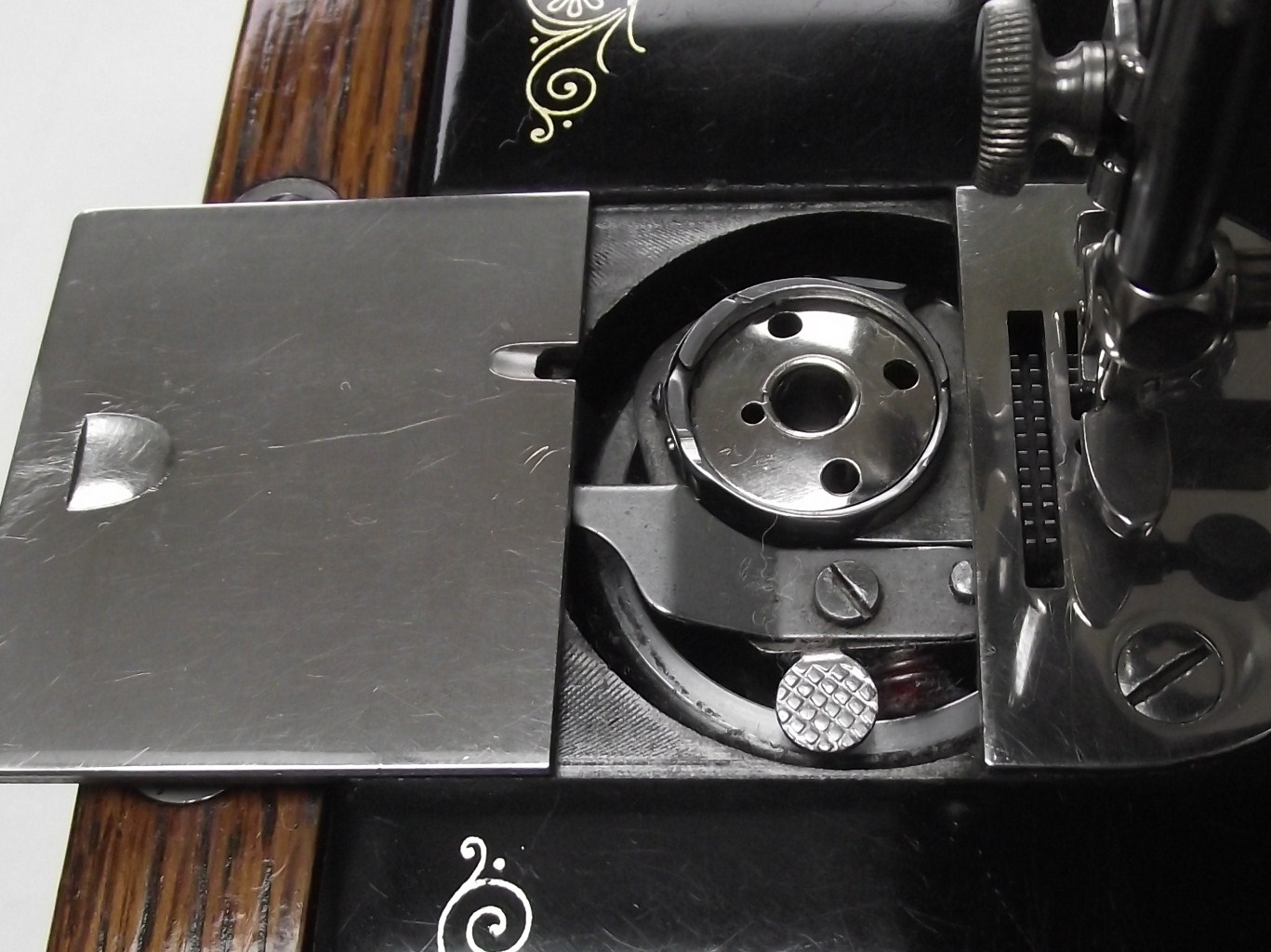 Lizzie Lenard Vintage Sewing Removing a Bobbin Plate from a Singer 99K