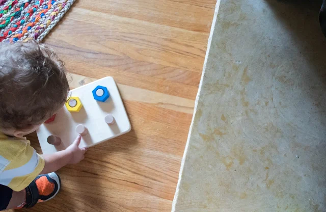 4 Montessori friendly tips to help your toddler learn to clean up after themselves.