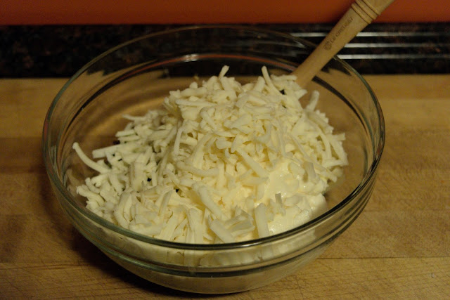 The shredded Monterrey Jack cheese being added to the mixing bowl. 