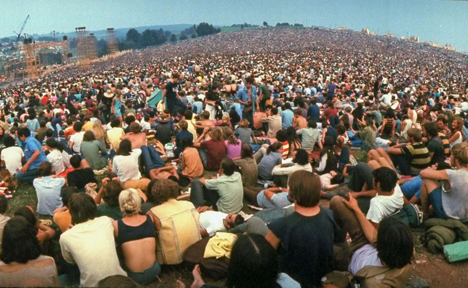 A wide-angle view of the huge crowd facing the distant stage during the Woodstock Music & Art Fair in August 1969.