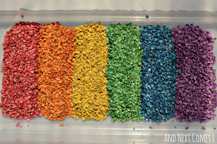 Colored oatmeal sensory bin for kids
