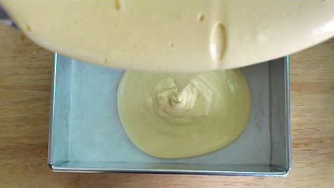 pouring castella cake batter into cake pan