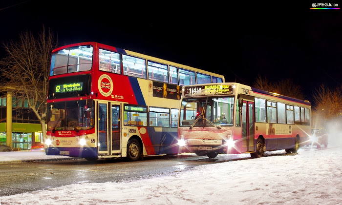 Photograph of buses in the snow at night