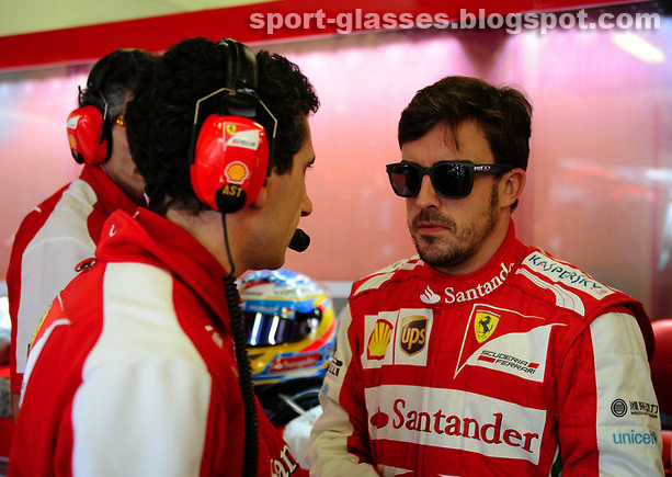 Fernando Alonso talking to his pit crew wearing Oakley Garage Rock Sunglasses