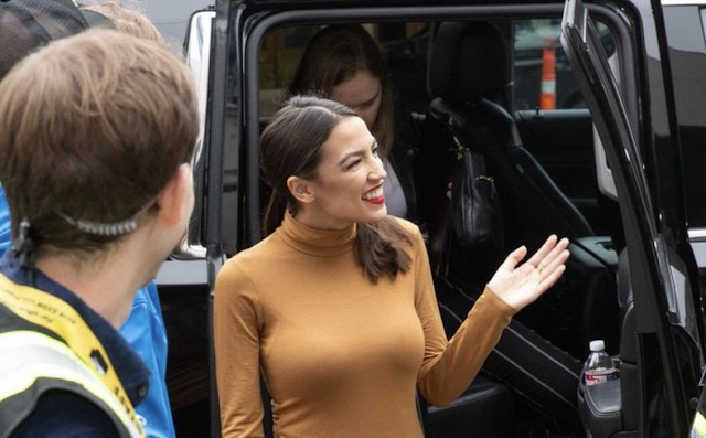 Figures. Alexandria Ocasio-Cortez is All Smiles as She Arrives at SXSW in a BIG GAS GUZZLER to Preach Green New Deal